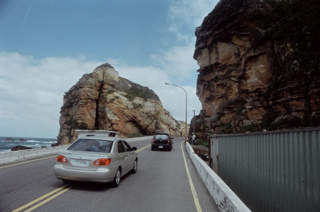 Cars on Road and Colourful Rock Formation